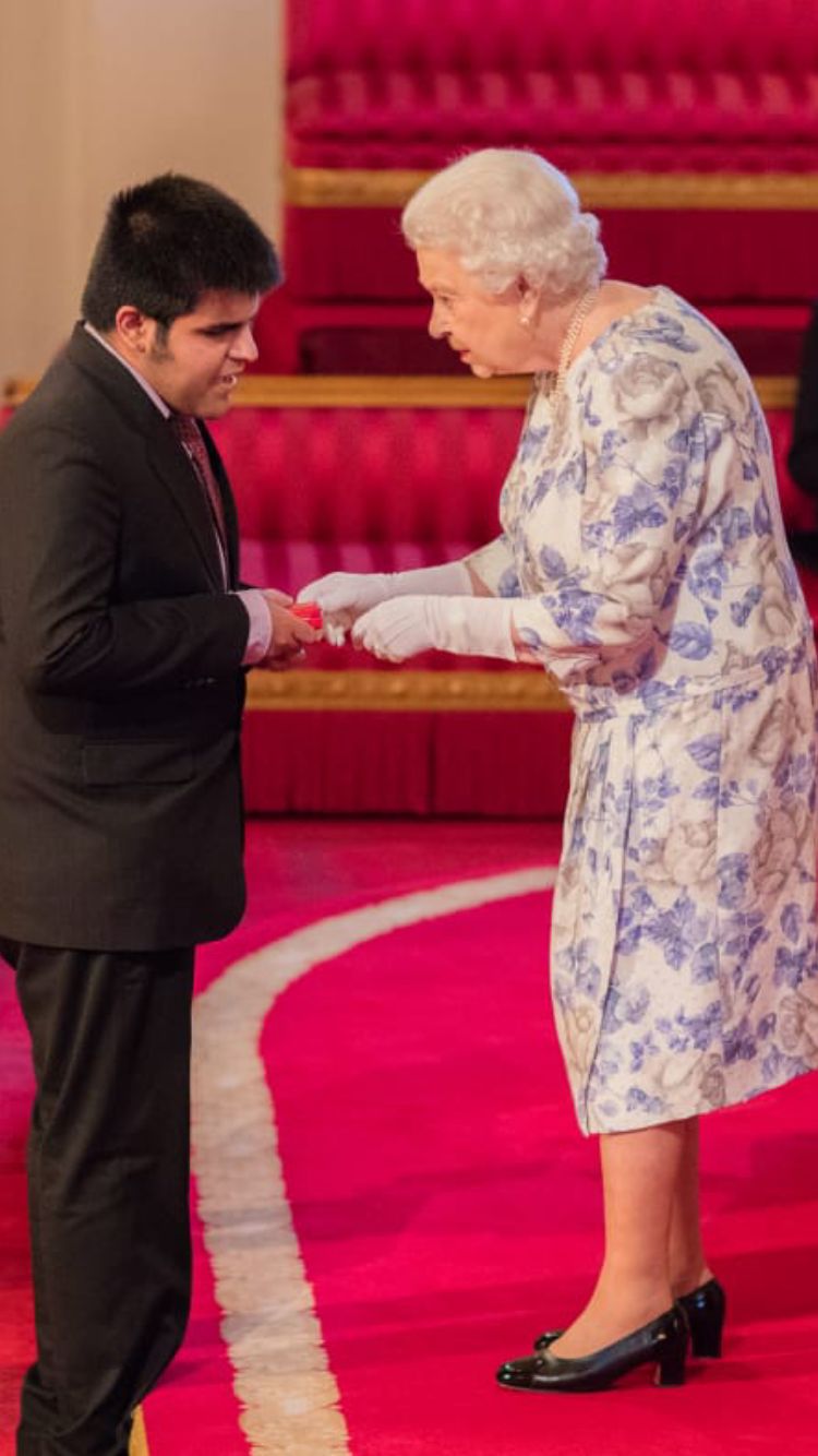 Kartik receiving award from Her Majesty the Queen